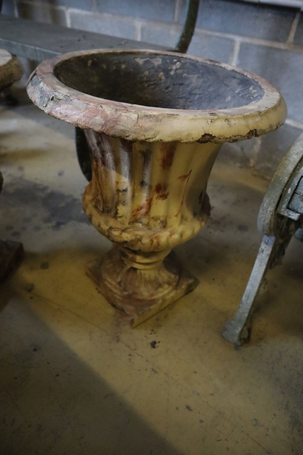 A pair of Victorian faux marble cast iron urn campana garden urns, 39cm diameter, height 46cm